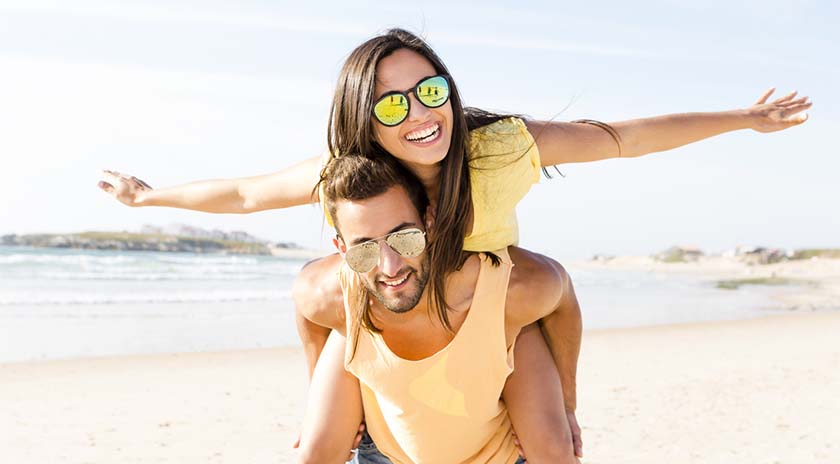 una pareja en la playa riéndose
